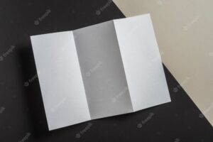 Elevated view of folded white paper for brochure