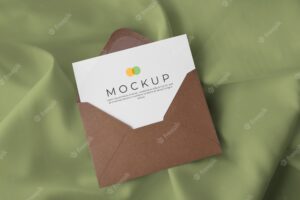Envelope with card on fabric background mockup