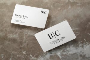 Floating business card over concrete surface mockup