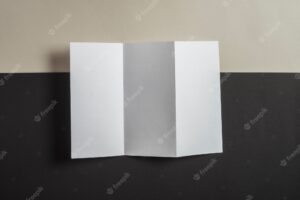 Folded blank paper on backdrop