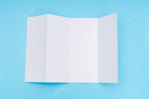 Four- fold white template paper on blue background .