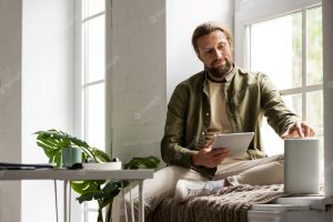 Front view man holding tablet