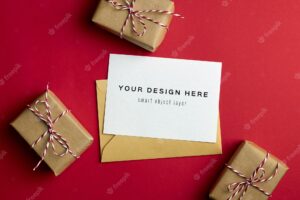 Greeting card mockup with christmas gift boxes on red paper background