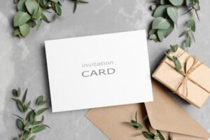 Greeting card mockup with gift envelope and fresh eucalyptus