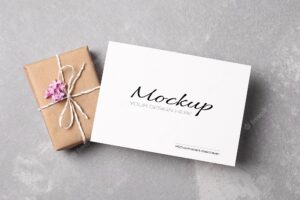 Greeting or invitation card stationary mockup with gift box