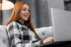 Happy female looking on laptop