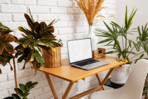 High angle laptop on table with plants