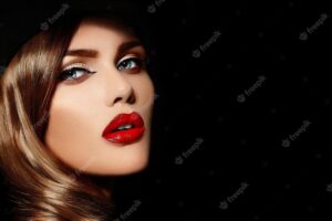 High fashion look.glamor closeup portrait of beautiful sexy stylish  caucasian young woman model with bright makeup, with red lips,  with perfect clean skin in big black hat
