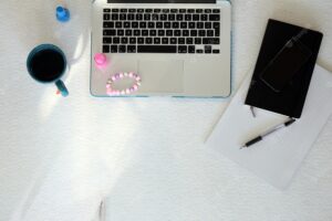 Laptop, smartphone, mug and nail polish
