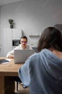 Man and woman working from home together at desk