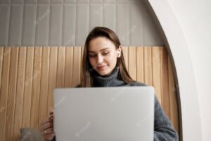 Medium shot woman holding laptop