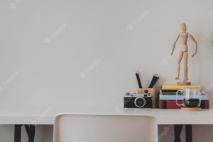 Minimal homeoffice with office supplies and decorations on white wooden table surface