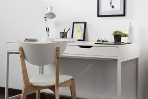Neat and organised workspace with chair and lamp