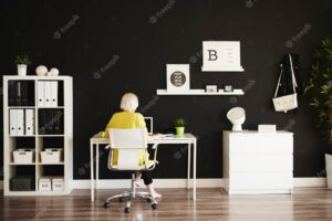 Rear view of businesswoman working at home office