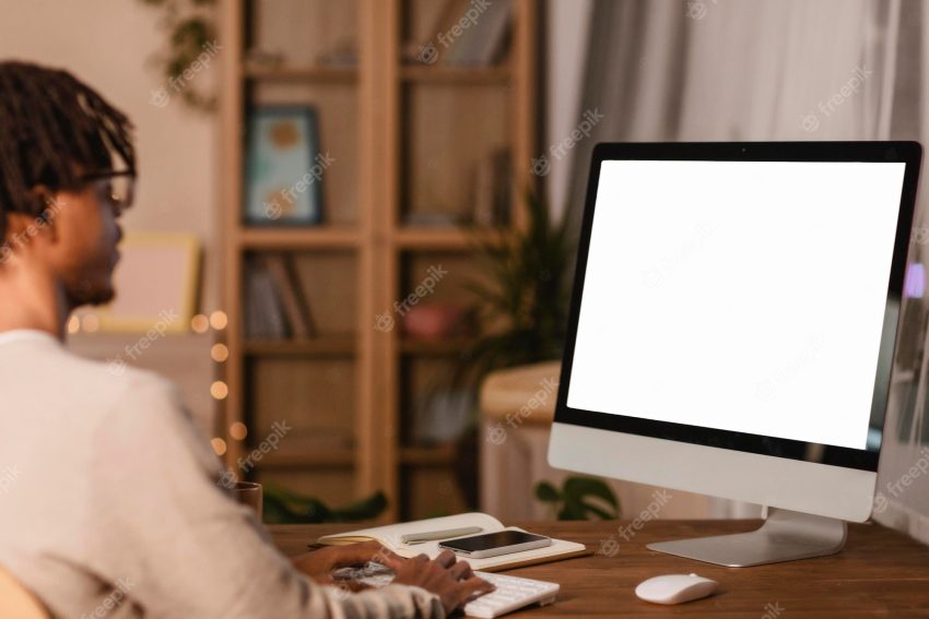 Side view of man using computer at home