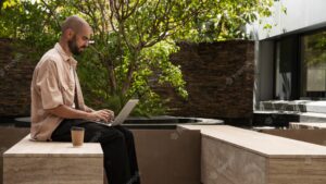 Side view man working on laptop