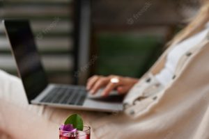 Side view woman holding laptop