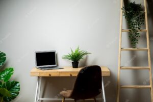Simple desk with chair and grey laptop