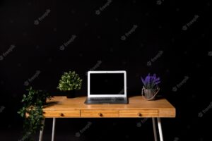 Simple wooden desk with gray laptop