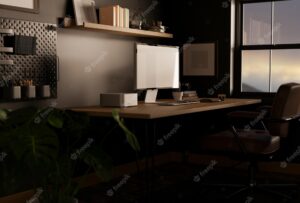 Stylish dark home office with computer mockup on table against the black wall trendy workspace