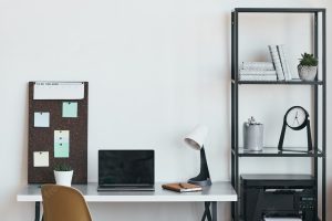 Vertical background image of minimal home office workplace with laptop and accessories in black and white, copy space