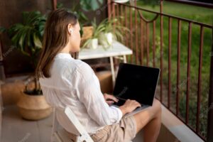 Woman in quarantine working at home on laptop