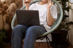 Young blonde woman working from home in her chair