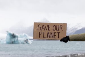 Activist holds a sign with an important message to humanity save our planet