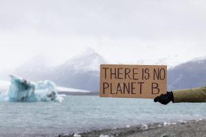 Activist holds a sign with an important message to humanity there is no planet b