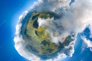 Aerial view from high altitude of little planet earth covered with white puffy cumulus clouds on sunny day.