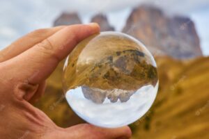 Alpine mountain view through crystal glass globe dolomites alps