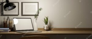 An artist designer working desk with laptop computer mockup and copy space on wood table 3d render
