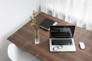 Business desk arrangement with laptop high angle