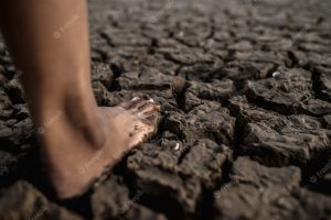 Children are walking barefoot on mud