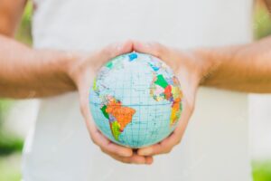 Close-up of man's hand holding small globe