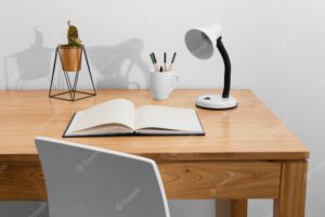 Desk arrangement with book and lamp