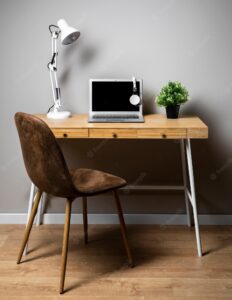 Desk with gray laptop and lamp