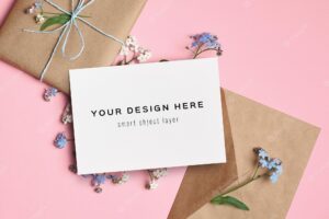 Greeting card mockup with gift box, envelope and flowers