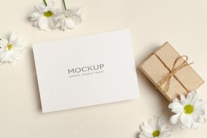 Greeting card mockup with gift box and flowers