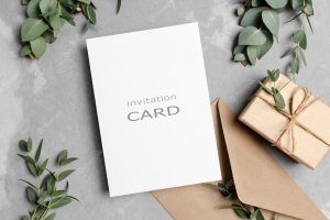 Greeting card mockup with gift envelope and fresh eucalyptus
