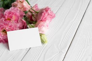 High angle of flowers with blank card