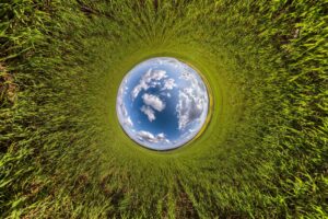 Inversion of little planet transformation of spherical panorama 360 degrees spherical abstract aerial view in field with awesome beautiful clouds curvature of space
