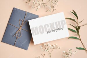 Invitation or greeting card mockup with envelope, eucalyptus and hypsophila twigs