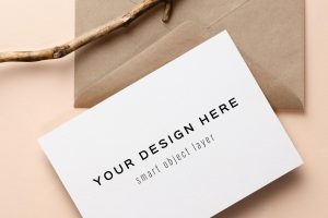 Invitation or greeting card mockup with envelope and wooden decorations