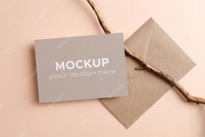Invitation or greeting card mockup with envelope and wooden twig decoration