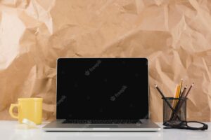 Laptop against brown paper texture