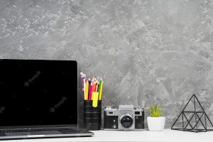 Laptop and office tools on desk