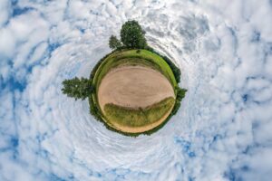 Little planet transformation of spherical panorama 360 degrees spherical abstract aerial view in field in nice evening with awesome beautiful clouds curvature of space