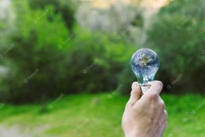 Male hand holding earth in glass bulb