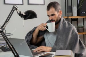 Man having coffee while working from home